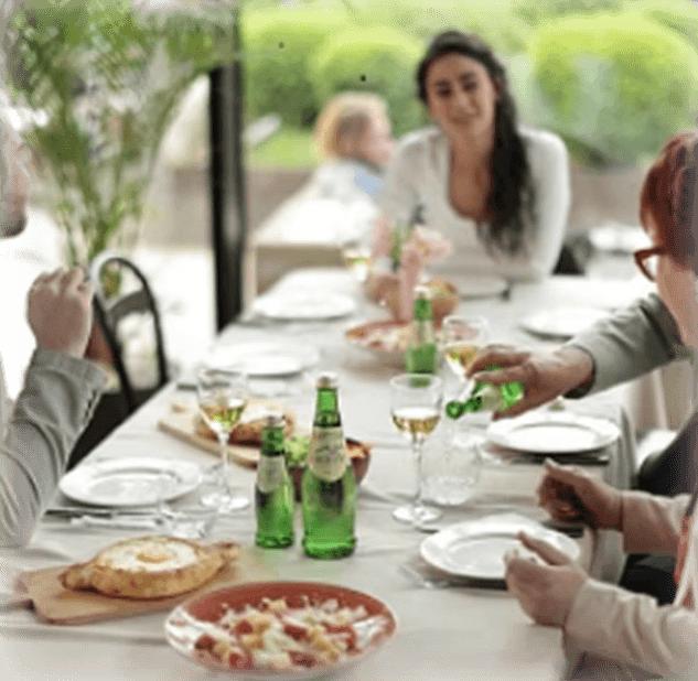 Family dining scene with mineral water
